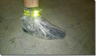 David's shoe covered in a wet, muddy plastic bag
