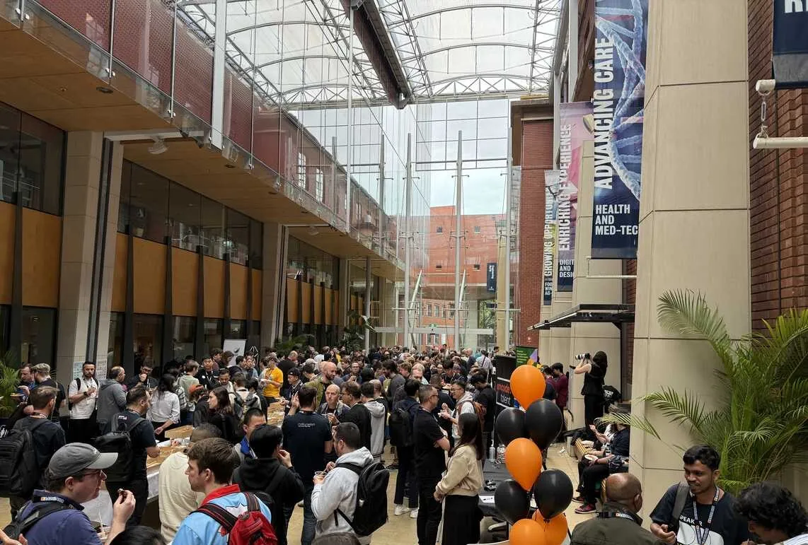 Lots of people milling around the atrium during morning tea