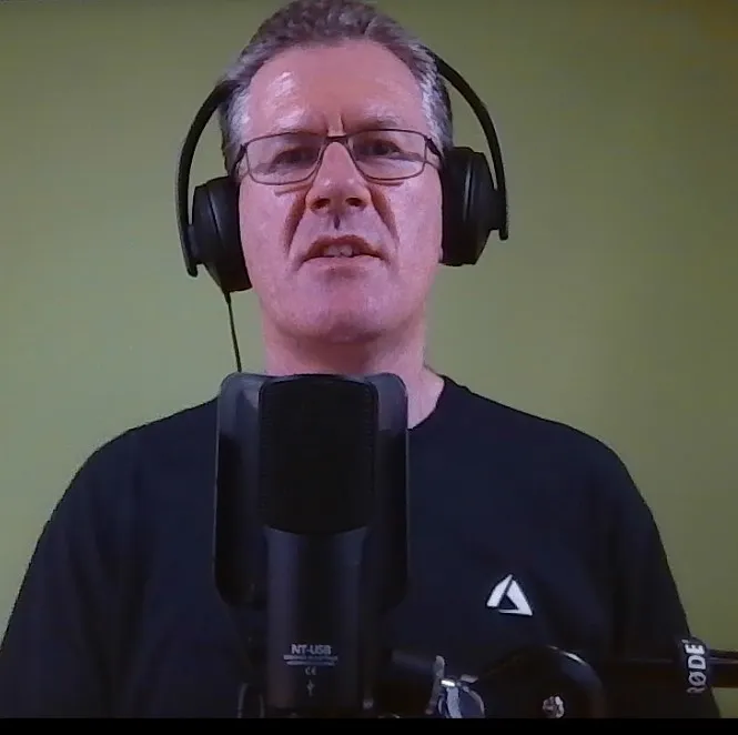 David speaking into the microphone