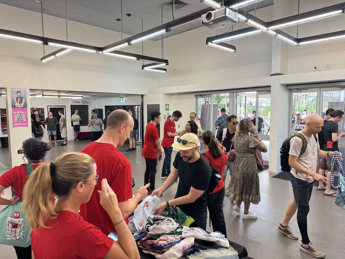 People registering and receiving their bags and lanyards