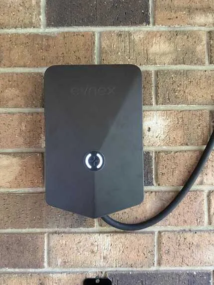 Evnex charger mounted on brick wall