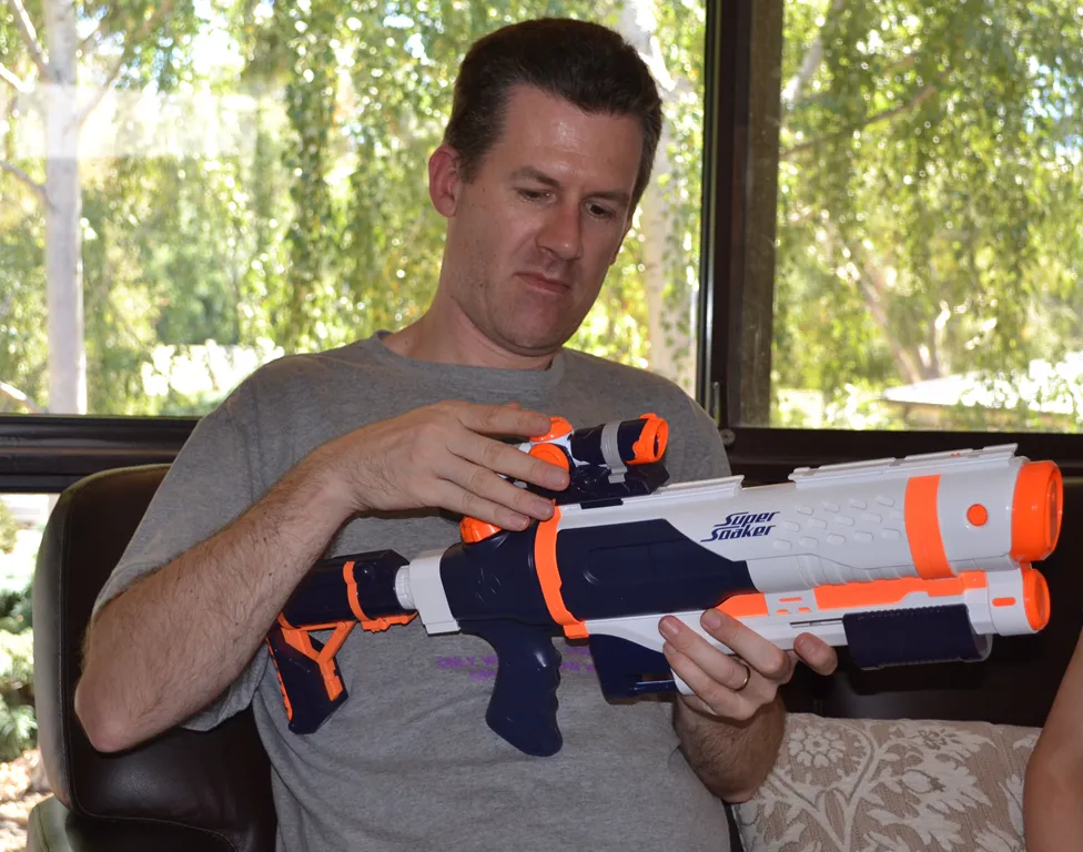David unwrapping a super-soaker water pistol