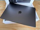 new MacBook Pro laptop sitting on the box it came in
