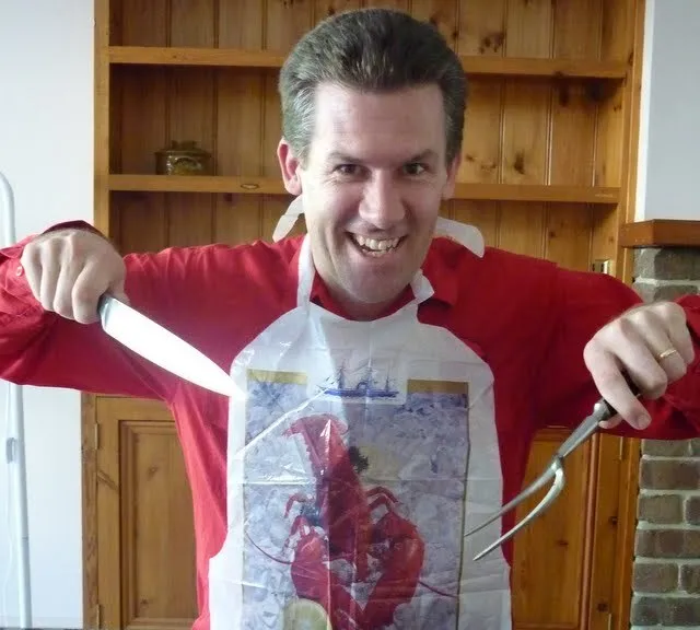 David holding a knife and fork