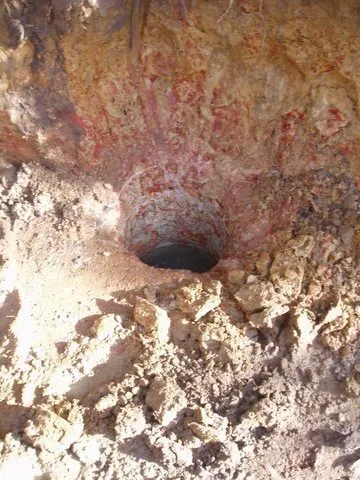 One of the holes for the retaining wall still half-full of water