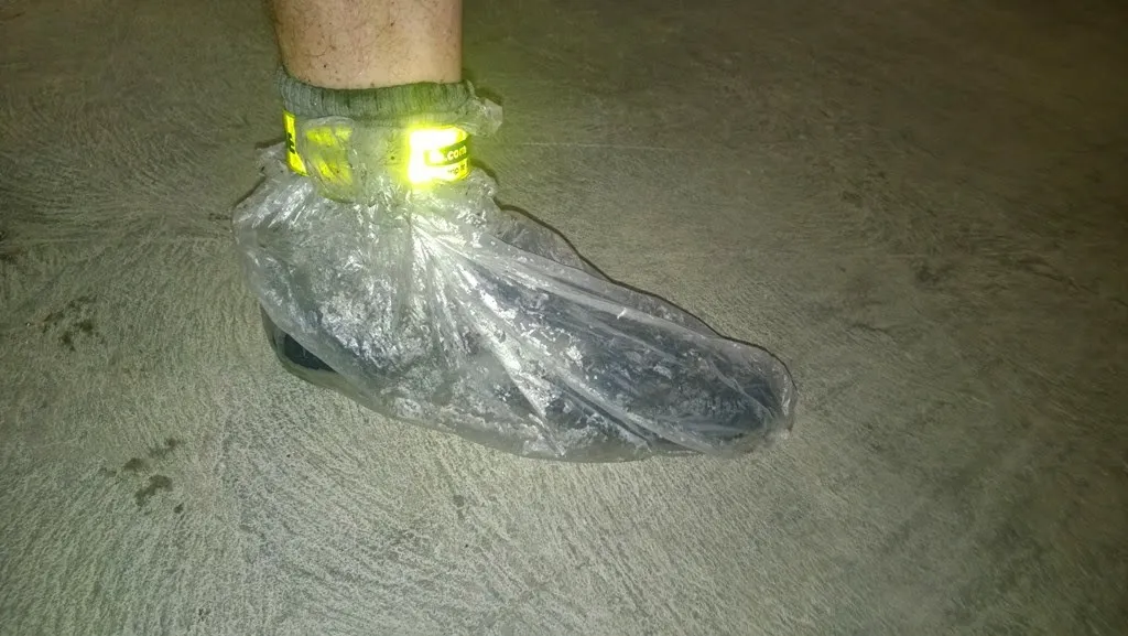 David's shoe covered in a wet, muddy plastic bag