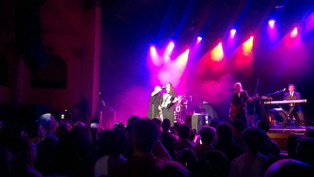 The tech guy helping hold Al's harmonica