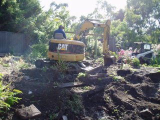 Excavator and Bobcat digging at our house