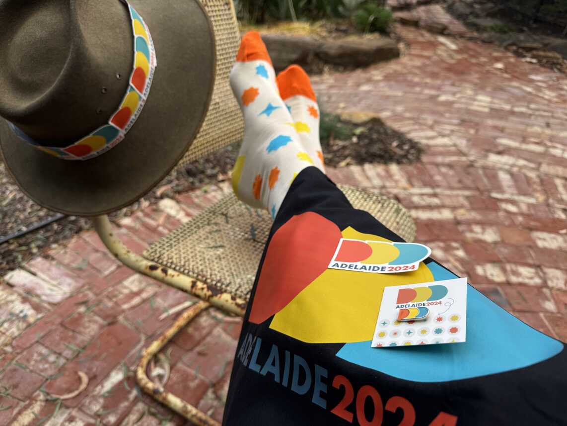 an Akubra hat with DDD sticker hatband, DDD socks, DDD tote bag, stickers and pin