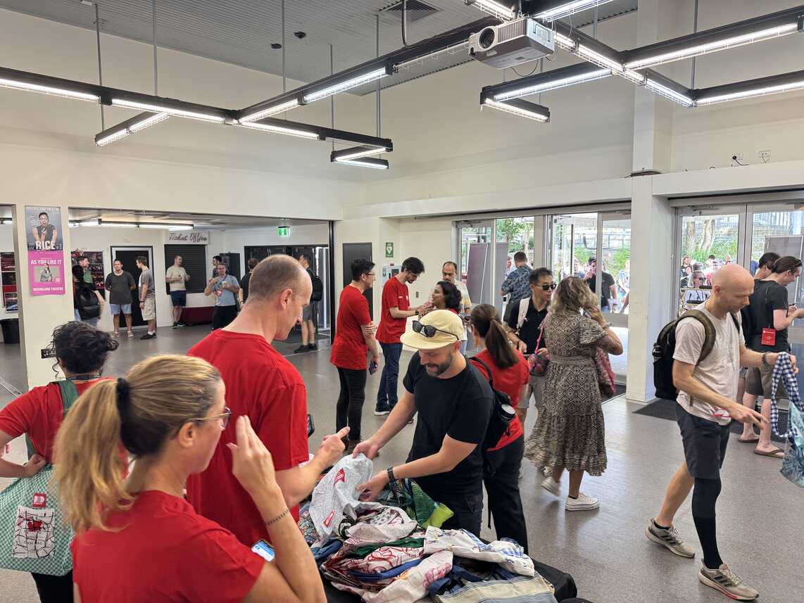 People registering and receiving their bags and lanyards